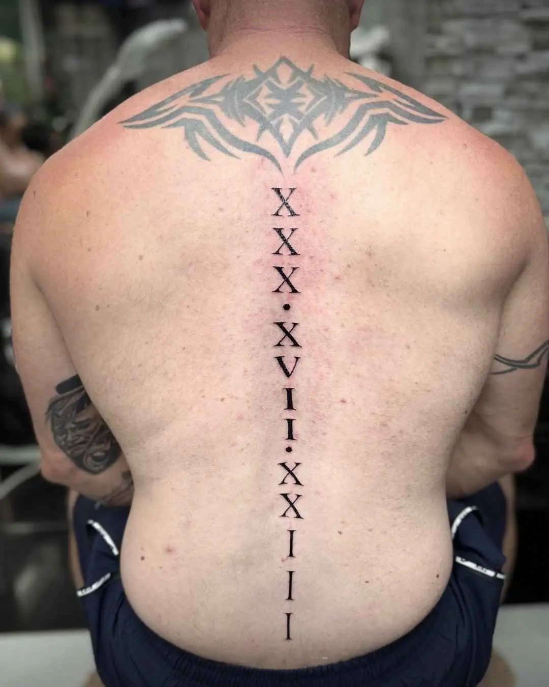 back fine line tattoo by fame tattoo